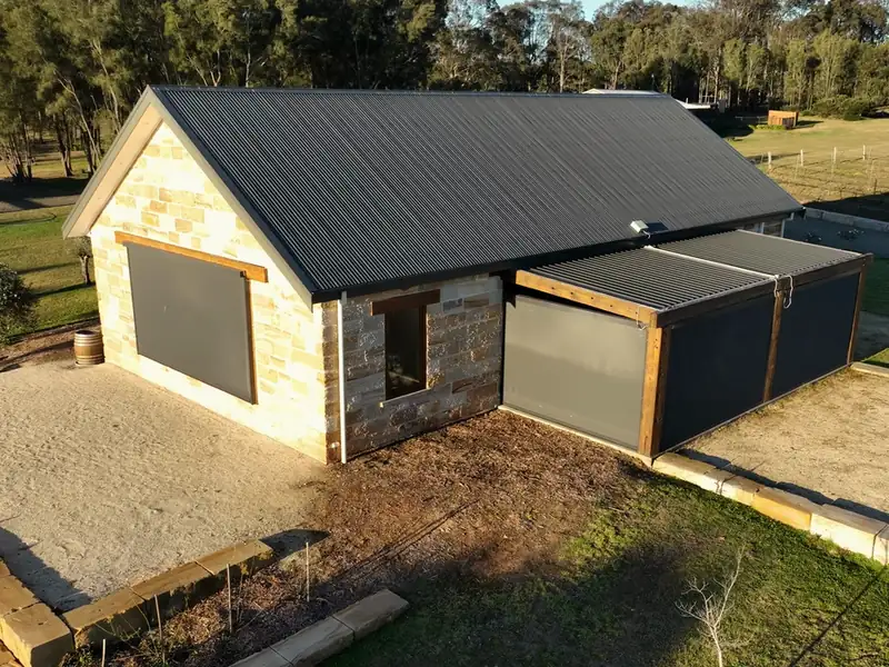 Outdoor blinds on a stone chapel, seen from the air