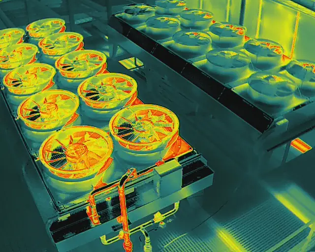 Close thermal view of condenser fans and warm refrigerant pipework